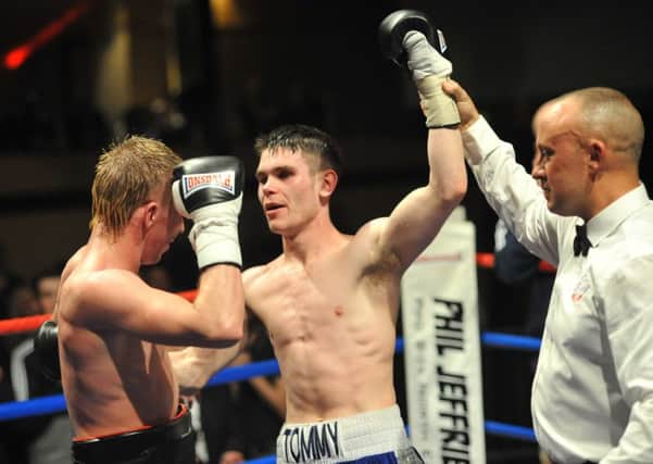Referee John Latham holds aloft the arm of Tommy Ward after victory over Robbie Turley. Picture by TOM COLLINS