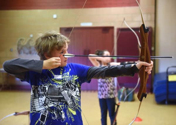 Youngsters enjoying archery in Summerhill Country Park.