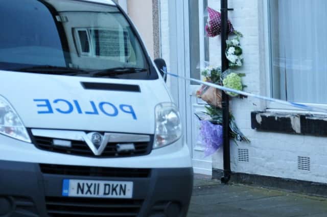 Flowers left outside the Stephen Street home of murder victem Angela Wrightson. Picture by FRANK REID