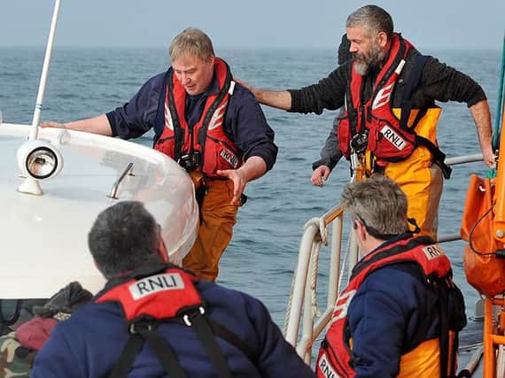 Hartlepool RNLI Assistant Mechanic Mark Barker transfers to the stricken fishing boat