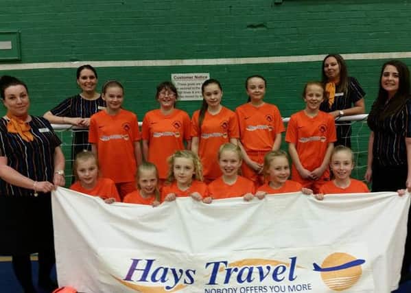 Easington Colliery under-11 girls with staff from Hays Travel.