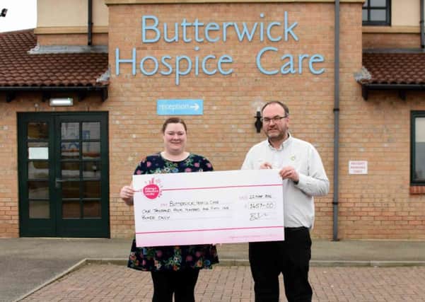 Store manager Brian McGregor presents the cheque to Jess Naylor at Butterwick Hospice.