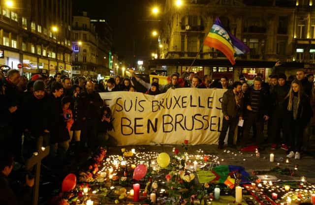 Members of the public gather at the Place de la Bourse in Brussels to leave messages and tributes following the terrorist bomb attacks