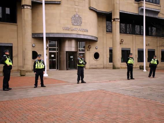 Police guarding Bradford Crown Court this morning. Picture by Peter Byrne/PA Wire.