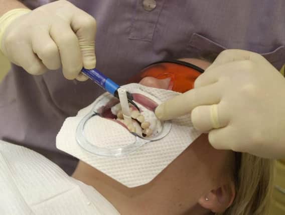 A dentist carrying out the procedure correctly.