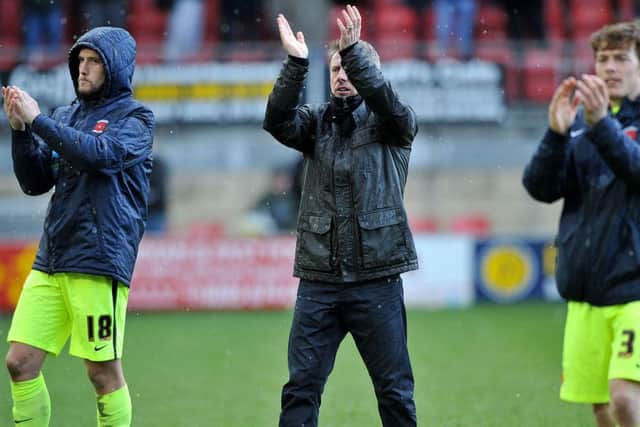 Craig Hignett applauds the fans at Leyton Orient with Lewis Hawkins (left) and Luke James. Picture by FRANK REID