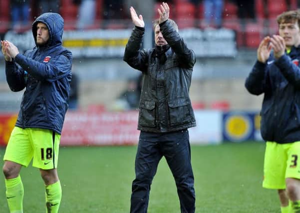 Craig Hignett applauds the fans at Leyton Orient with Lewis Hawkins (left) and Luke James. Picture by FRANK REID
