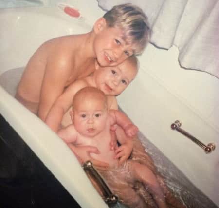 From left to right, Aaron, Nathan and Eldon Myers as children in their parents' bath. Picture from Mercury Press.