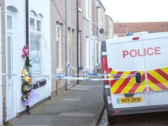 Flowers left at the house where Angela Wrightson was murdered