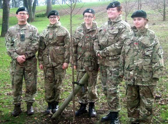 Army cadets with one of the trees they planted in North Cemetery.