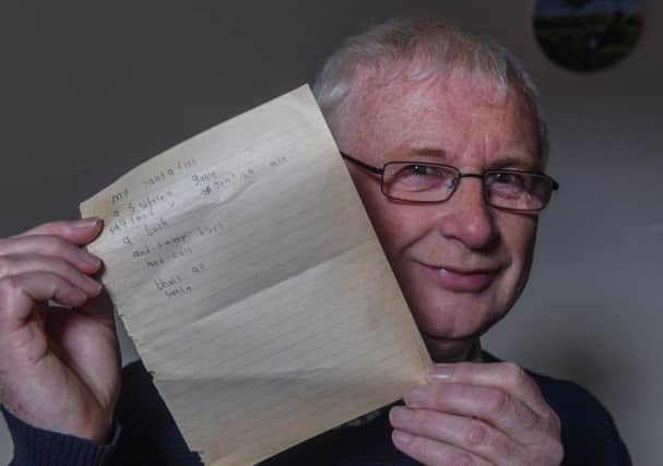 Ray Trench with his brother Pauls Christmas list, which was written in 1966 and uncovered last year.