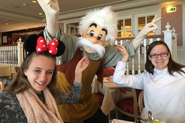 Estella, 15, and Chiara, 14  meet Disney characters.