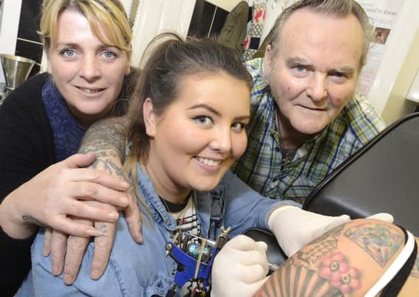 Eddie Hardiman, Trudy Hardy and Shannon Hardy working together at Eddies Tattoo Studio in Horden.