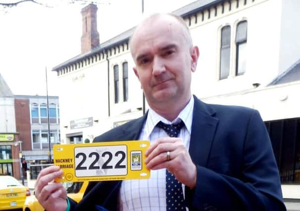 Ian Harrison with a licence plate bearing the retired number belonging to Ray Tweddle.