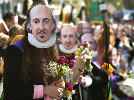 Members of the public wear William Shakespeare masks during the parade marking 400 years since the death of the playwright in Stratford-upon-Avon, Warwickshire.