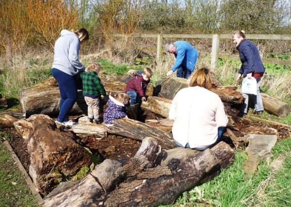 Youngsters and their parents enjoying an outdoor activity at Summerhill Country Park and Visitor Centre.