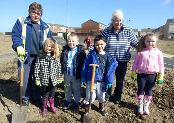 Pupils help plant trees at Central Park.