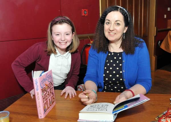 Author Cathy Cassidy signing a copy of her latest book for St Cuthbert's Primary School pupil Hope Jordison (10) in the Town Hall. Picture by FRANK REID