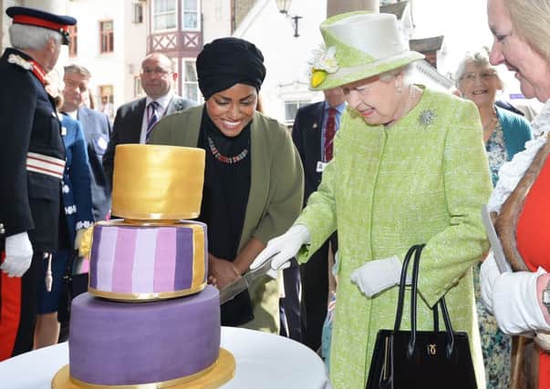 The Queen cuts a cake on the official day of her birthday last month.