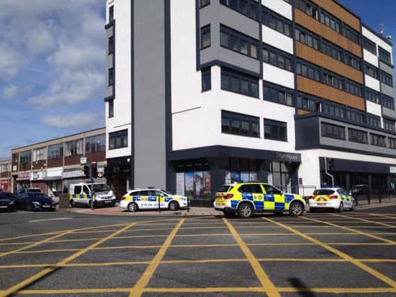 The armed police are outside of Titan House.