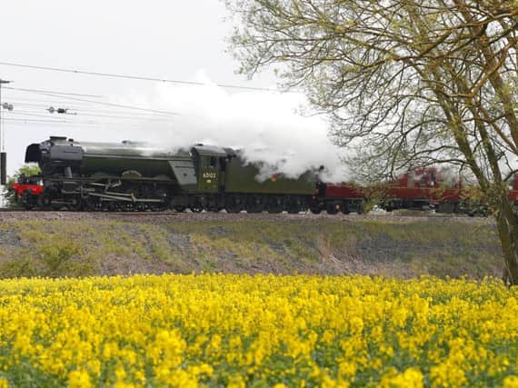 The Flying Scotsman passes a rapeseed field near Durham, as part of its UK tour.