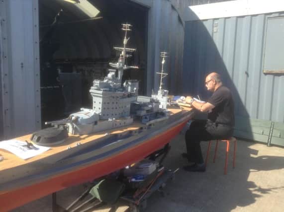Glenn Bauke works on the model of HMS Warspite
