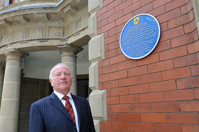 Eric Elliott QC president of  West Hartlepool Grammar School Old Boy Association looking at the blue plaque at Hartlepool 6th Form College.