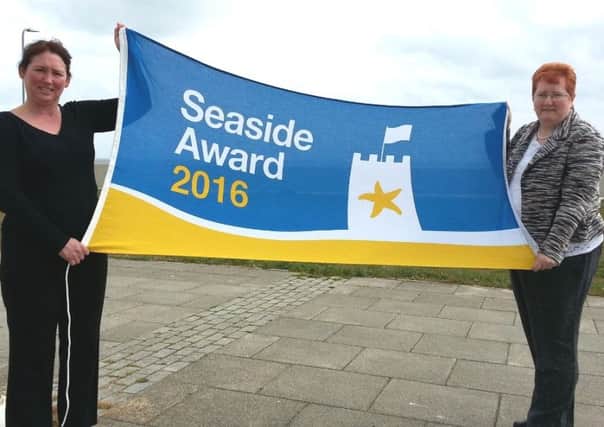 Debbie Kershaw, the Councils Quality and Safety Officer (left), and Councillor Marjorie James raise the Seaside Award flag at Seaton Carew.