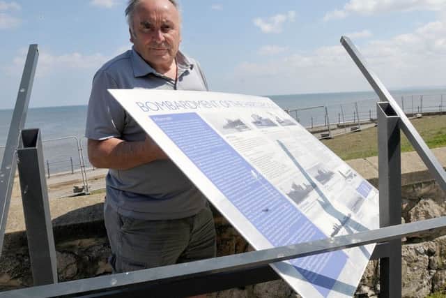 John Cambridge with the damaged bombardment sign . Photograph by FRANK REID