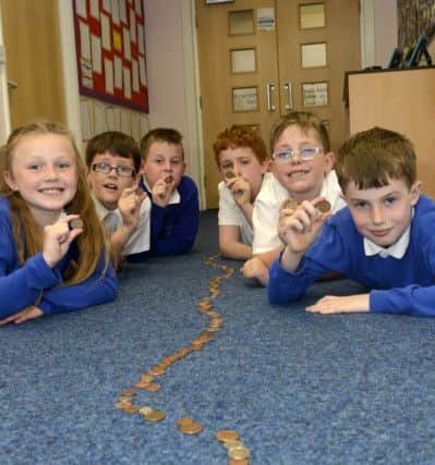 Darci Abbey, James Holland, Callum Smiles, Ben Curry, Reece Hall and Shaun Dennis with the trail of coins for UNICEF at Eskdale Academy