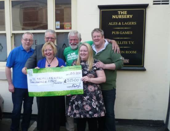 George Newbury, third right, receives the cheque on behalf of Macmillan after the fundraising events.