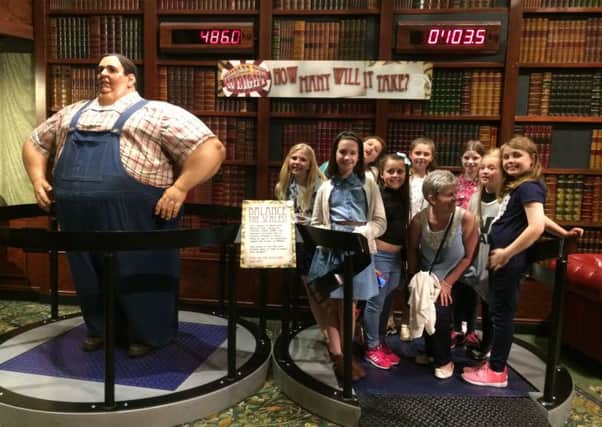 The kids weigh up an unusual exhibit in Ripley's Believe It or Not