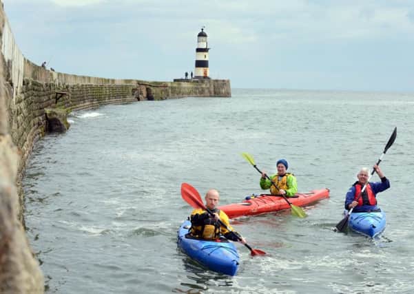 Wayne Gibson, East Durham Area Action Partnership community development project officer, Colin Burn, watersports development officer at Seaham Marina, and Niall Benson, heritage coast officer, give kayaking a go.