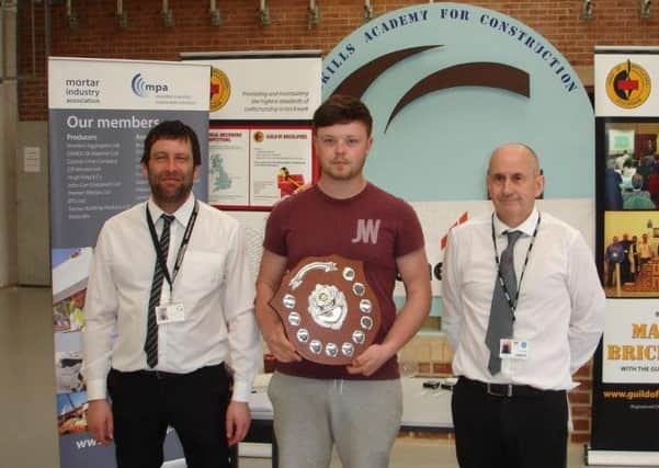 Award-winning apprentice bricklayer Aaron Armstrong, a Hartlepool College student, is presented with his award.