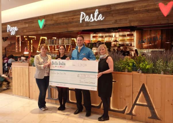 Bella Italia staff hand over the cheque to the Denise Taylor Cancer Trust.