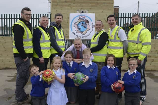 St Bega's pupils Logan Dennis, Maisie Amerigo, Amy Saxon, Kalan Richardson, Frankie Wood and Cole Byron with headteacher Mike Cooney and Karl Briggs, David Morrison, Andy Wilson, Mick Langley, Craig Chapman and Mickey Rowell from Interserve Construction, with the new sports area.