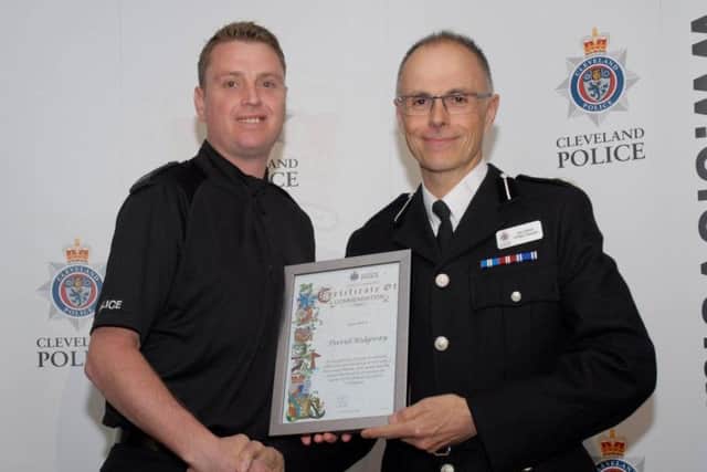 Pc David Ridgeway is presented his certificate by Temporary Chief Constable Iain Spittal.