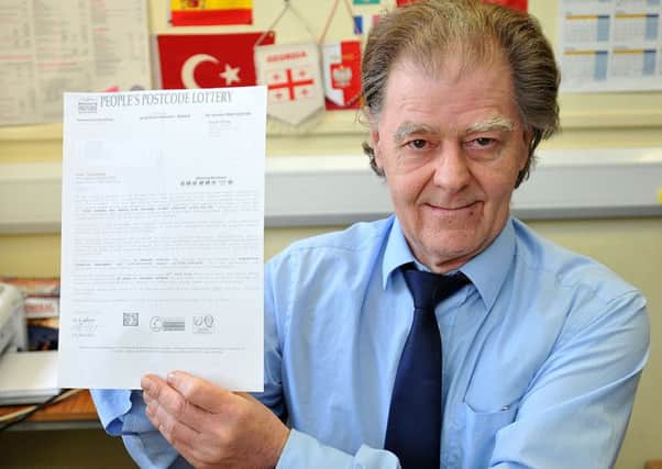 Citizen's Advice Bureau Manager Joe Michna with a copy of the Postcode Lottery scam letter. Photograph by FRANK REID