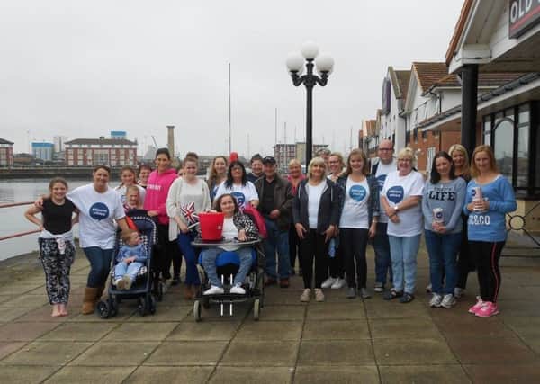 The staff, volunteers, friends and relatives of Citizens Advice Hartlepool at the end of their sponsored walk at Hartlepool marina