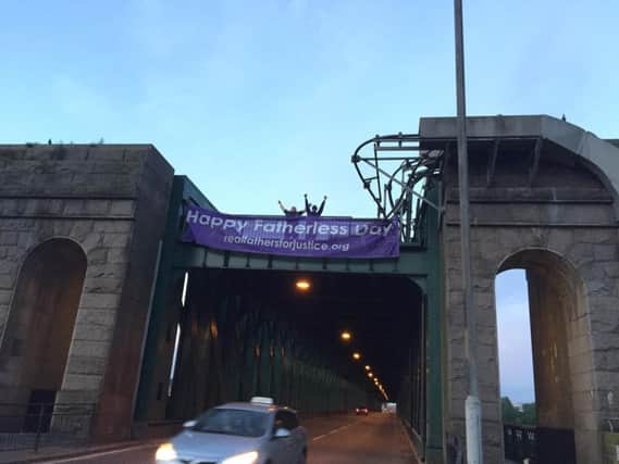 Two dads scaled the Queen Alexandra Bridge to stage a Father's Day protest