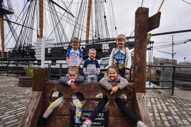 In the stocks, l-r standing Callum Simpson (4), Kayden Orley (2) and Harry Skinner (4) and front Tilly (4) and Kacey (9) Simpson all of Hartlepool, at the Hartlepool National Museum of the Royal Navy on Saturday.