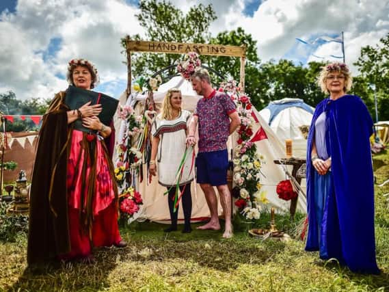 Fiona Wilkins and Craig Robson take part in a traditional handfasting ceremony held by ceremony celebrants Glenda Procter, left, and Jayne Tobey at the Glastonbury Festival.