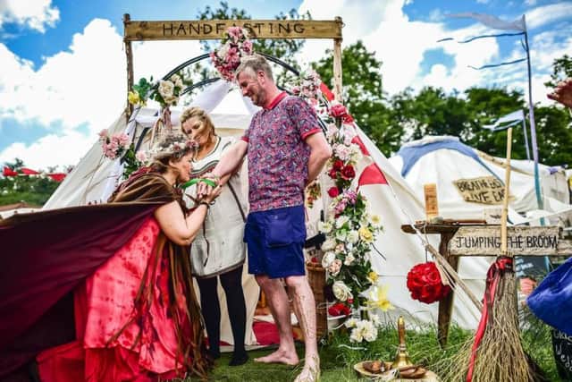 Fiona Wilkins and Craig Robson take part in a traditional handfasting ceremony held by ceremony celebrant Glenda Procter at the Glastonbury Festival, at Worthy Farm in Somerset.