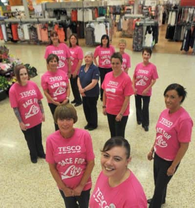 Selina Wilson (front) with fellow Tesco staff who are taking part in the 206 Race For Life.