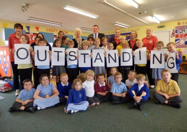 Councillor Alan Clark (back centre) is pictured with Oscars staff and children celebrating their outstanding Ofsted rating.