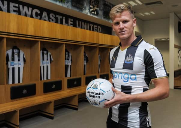 NEWCASTLE UPON TYNE, ENGLAND - JULY 1: New signing Matt Ritchie poses for a photo in the home dressing room wearing the new NUFC 2015/16 shirt and holding a ball at St.James' Park on July 1, 2016 in Newcastle upon Tyne, England. (Photo by Serena Taylor/Newcastle United via Getty Images)