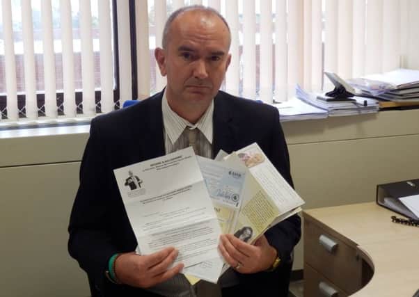 Ian Harrison, the councils trading standards and licensing manager, with a fraction of the letters sent to one pensioner who was conned out of Â£55,000