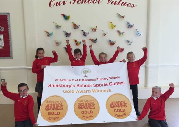 St Aidans C of E Memorial Primary School pupils celebrate gaining the Sainsburys School Games Award Gold Standard for the third year in a row.