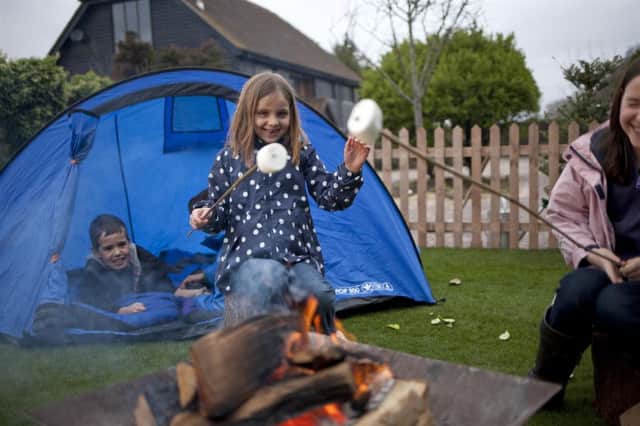 Children toasting marshmallows as part of the Big Wild Sleepout.