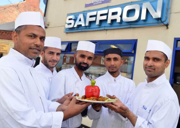 Saffron takeaway is up for an English Curry Award. Left, owner Bablu Miah with staff.
